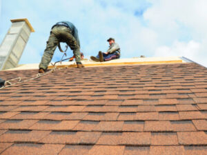 Two technicians working on a roof